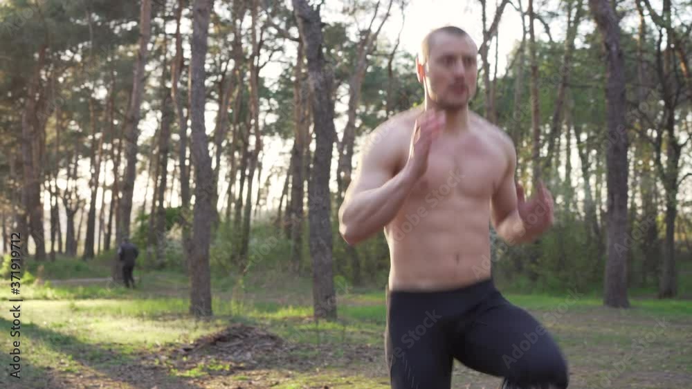 Handsome caucasian men outdoor workout cross training morning workout. Stretching arm before exercising outside sports ground nature forest Healthy lifestyle Young adult male fit body on fresh air Handsome caucasian men outdoor workout cross training morning workout. Stretching arm before exercising outside sports ground nature forest Healthy lifestyle Young adult male fit body on fresh air