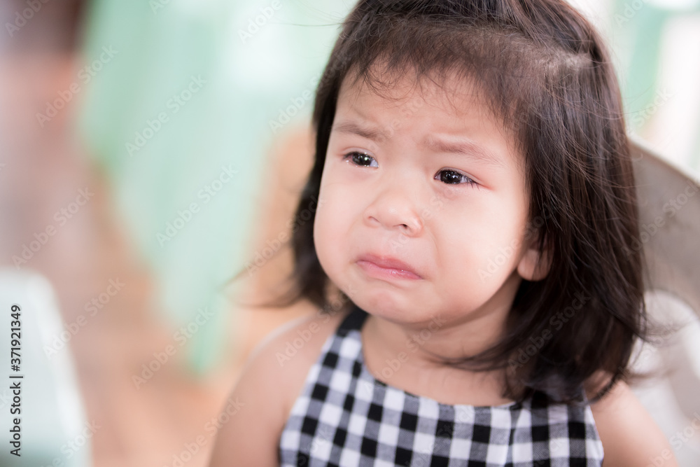 Close Up portrait of upset Asian adorable little girl. Cute child is crying pout her mouth, tears flow on her cheeks. Kid aged 3 years old. Candid Sad face. Close Up portrait of upset Asian adorable little girl. Cute child is crying pout her mouth, tears flow on her cheeks. Kid aged 3 years old. Candid Sad face.