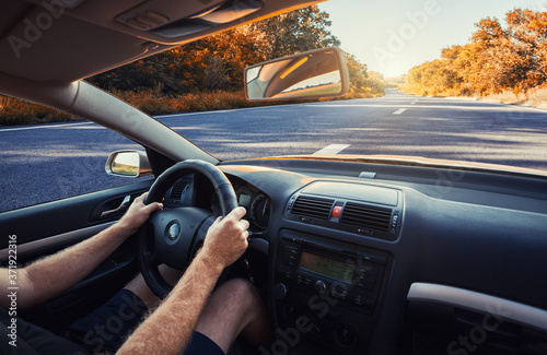 Car dashboard and steering wheel whith hand inside of car. Travel concepte © Dmytro Titov