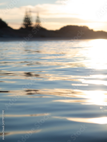 Small waves breaking on a surf beach, New Zealand. 