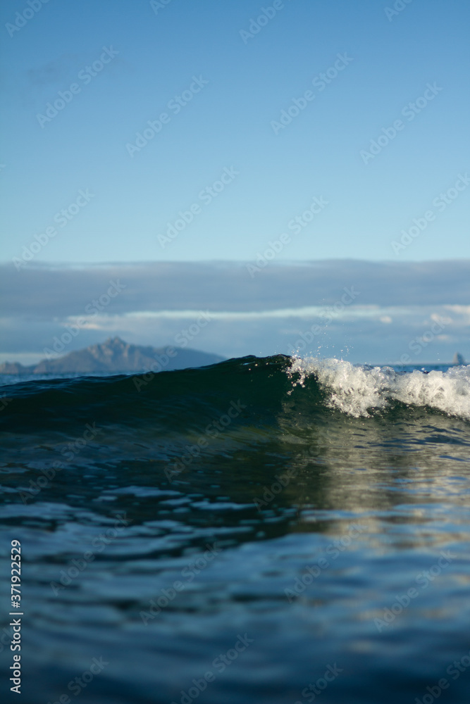 Small waves breaking on a surf beach, New Zealand. 