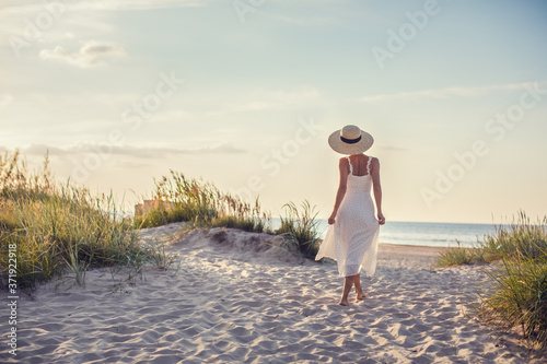Woman at the beach in sunset
