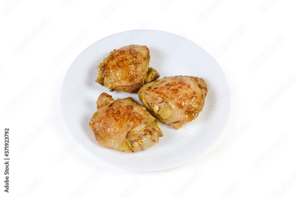 Crispy baked chicken thighs on the white dish Crispy baked chicken thighs on the white dish