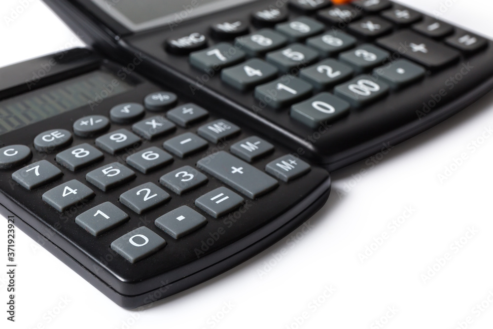 Keyboards of two different calculators close-up in selective focus Keyboards of two different calculators close-up in selective focus