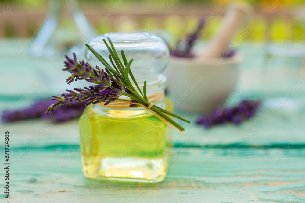 Homemade lavender flower oil on a wooden table. Homemade lavender flower oil on a wooden table.