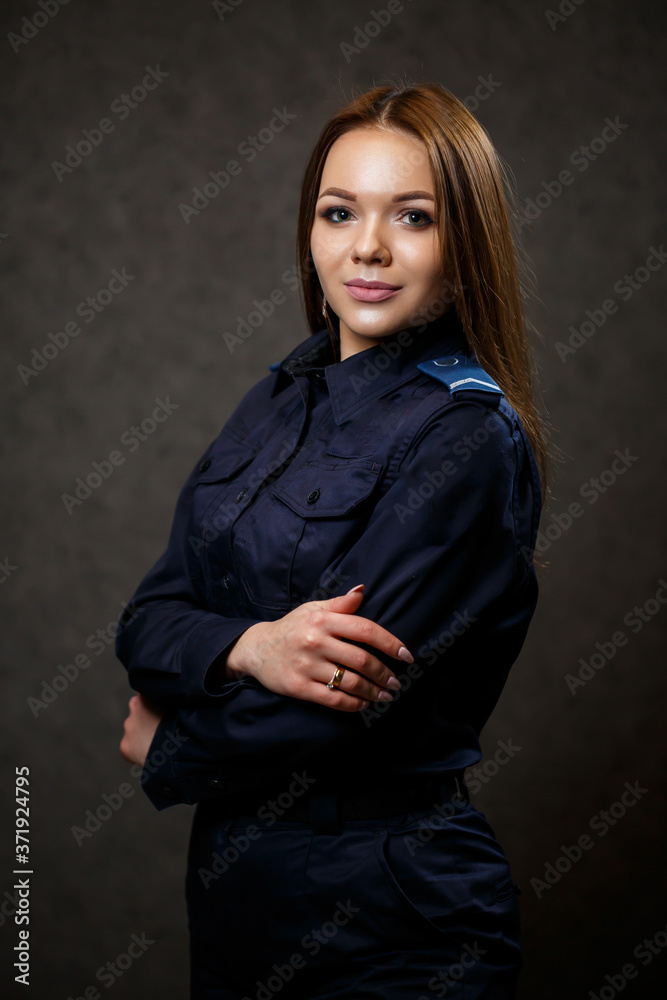 portrait of a beautiful girl in police uniform. Professional posing