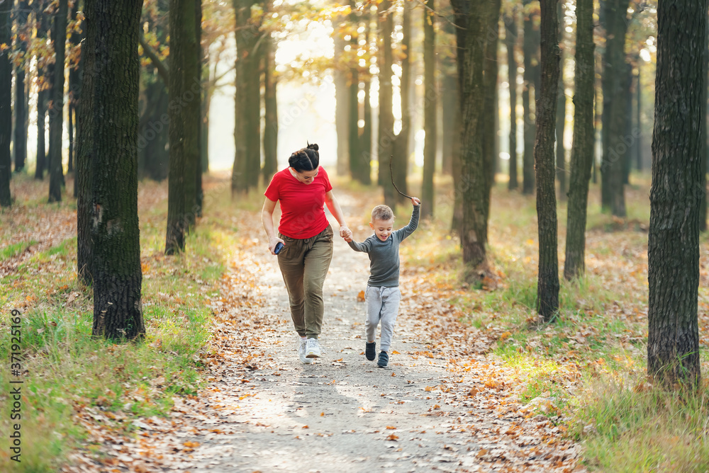 Mom runs with her son in the park