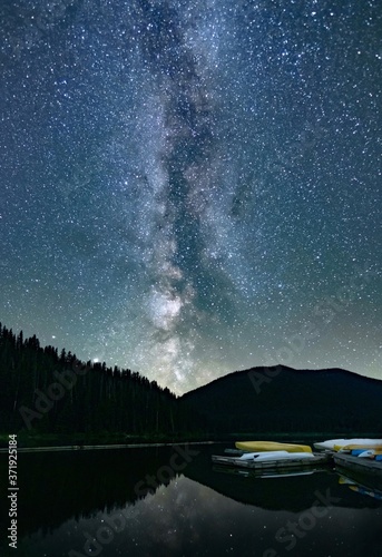 Obraz na plátně The Milky Way over the lake and stars reflection in calm water