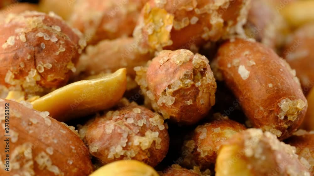 Peanuts super macro background texture. Roasted salty nuts closeup rotating. Peanuts super macro background texture. Roasted salty nuts closeup rotating.