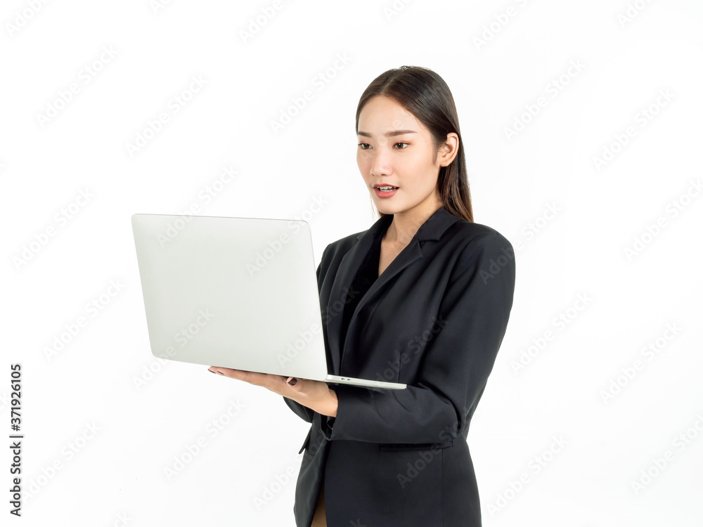 Asian smiling business women wearing suit using laptop computer isolated on white background. Asian smiling business women wearing suit using laptop computer isolated on white background.
