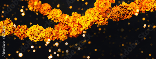 Marigold flowers Garlands on black. Dia de los muertos day, day of the dead or halloween banner, copy space photo