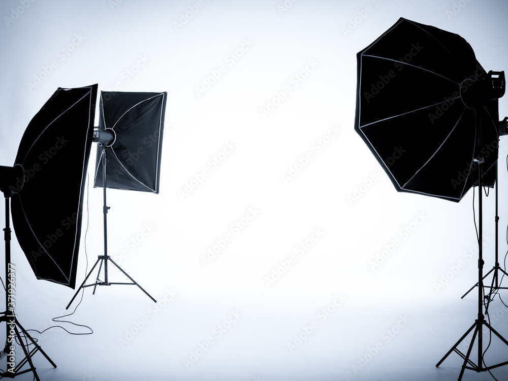 Empty white background in photography studio interior with lighting set