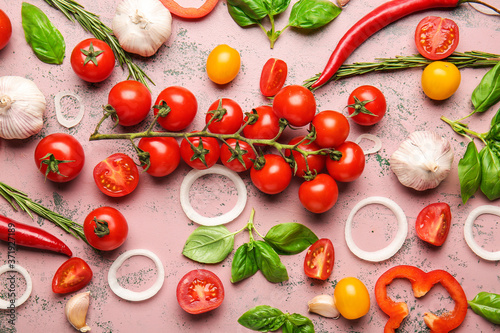 Composition with fresh cherry tomatoes, herbs and spices on color background