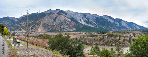 Panoramic views of the picturesque Fraser River Valley in autumn. Benches on the viewpoint above the river valley. The mountain range rises above the valley. Lillooet, BC, Canada