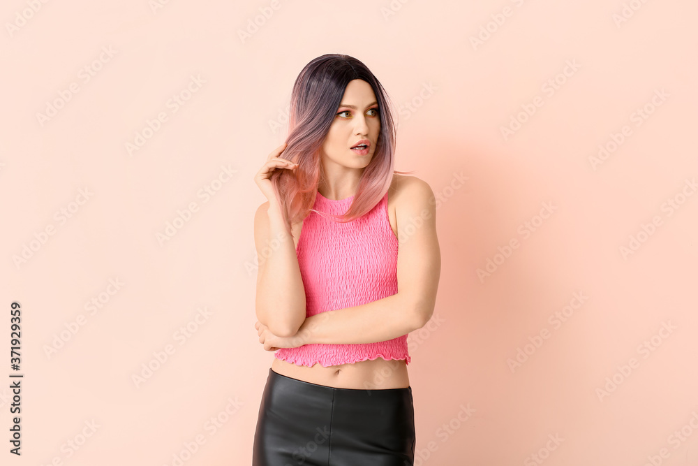 Beautiful young woman in wig on color background Beautiful young woman in wig on color background