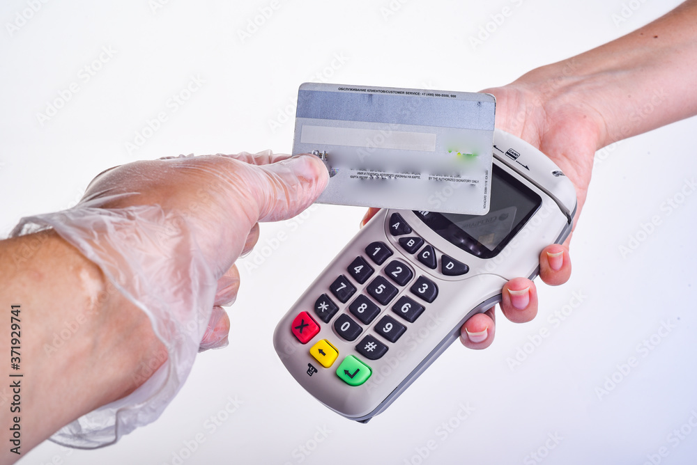 payment terminal. The buyer pays by card. Hands with gloves. Seller's hand in a glove. Buyer's hand in a glove. Safe shopping concept payment terminal. The buyer pays by card. Hands with gloves. Seller's hand in a glove. Buyer's hand in a glove. Safe shopping concept