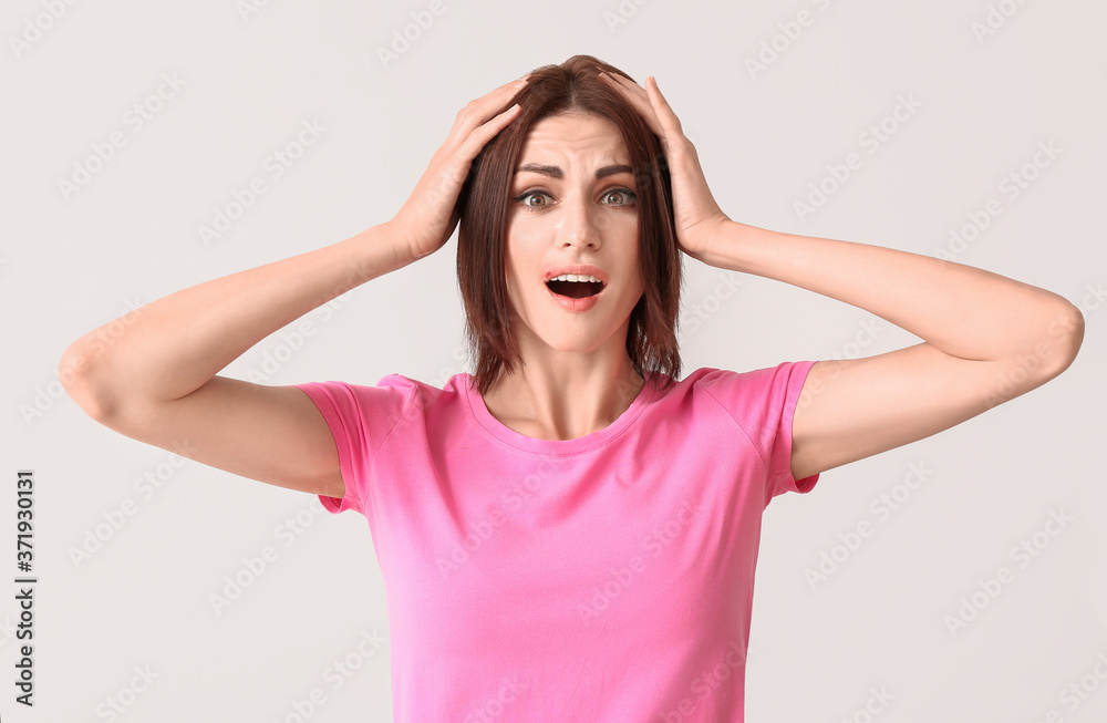 Stressed young woman with cold sore on light background Stressed young woman with cold sore on light background
