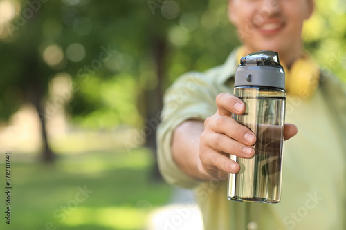 Young man with bottle of wa...