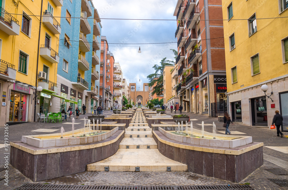 Cosenza, Italy - May 7, 2018: View of modern stairs street via Arabia with fountains, multicolored buildings and church of Parrocchia Teresa del Bambino Gesu, Calabria