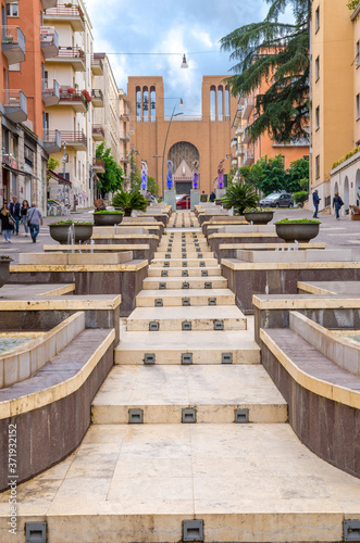 Cosenza, Italy - May 7, 2018: View of modern stairs street via Arabia with fountains, multicolored buildings and church of Parrocchia Teresa del Bambino Gesu, Calabria © Aliaksandr