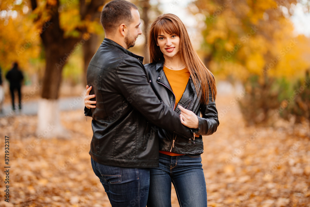 couple hug in autumn park near river. couple hug in autumn park near river.