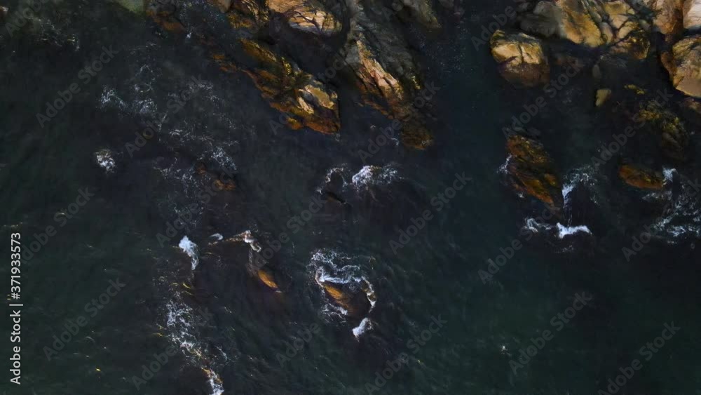 Aerial still of coastal waves crashing on rocks Aerial still of coastal waves crashing on rocks