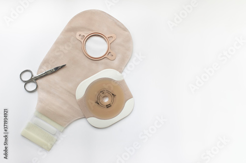Two piece ostomy appliance including flange and pouch isolated a a white background photo