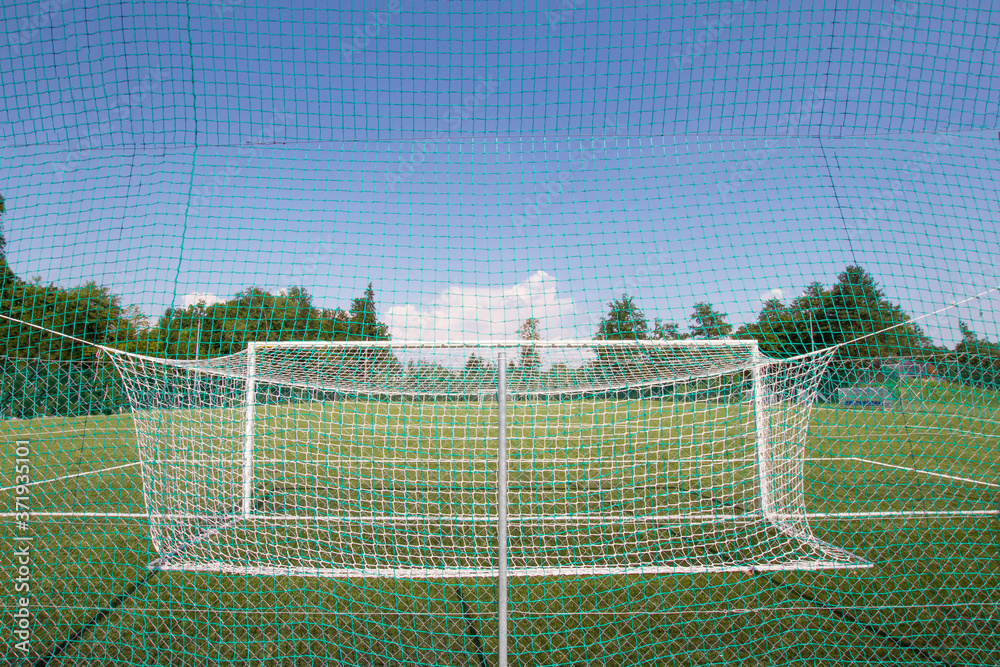 Fototapeta premium Soccer football goal in a large soccer football field. Isolated soccer goal