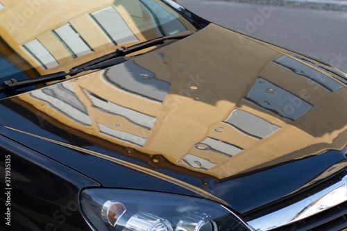 Serious hail storm damage on a parked car. Dented and damaged car after hailstorm.