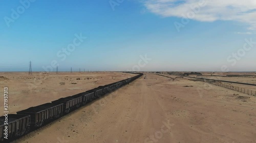 Train. Train in Mauritania. Train carrying coal. Industry in Mauritania. Filming from a drone. Footage. Mauritania in 4k. Africa in 4k