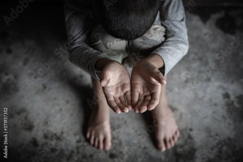 closeup hands poor child begging you for help concept for poverty  people, Human Rights. photo