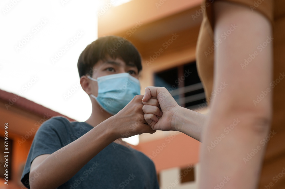 Asian man and women shake hand no touching to protect corona virus concept new normal social distancing