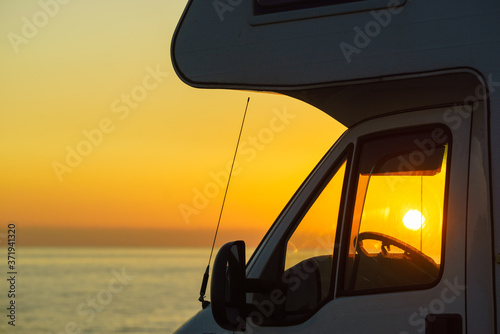 Caravan on coast at sunset