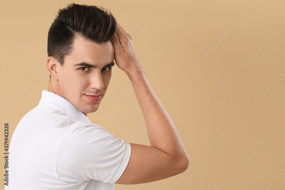 Handsome man with stylish hairdo on color background Handsome man with stylish hairdo on color background