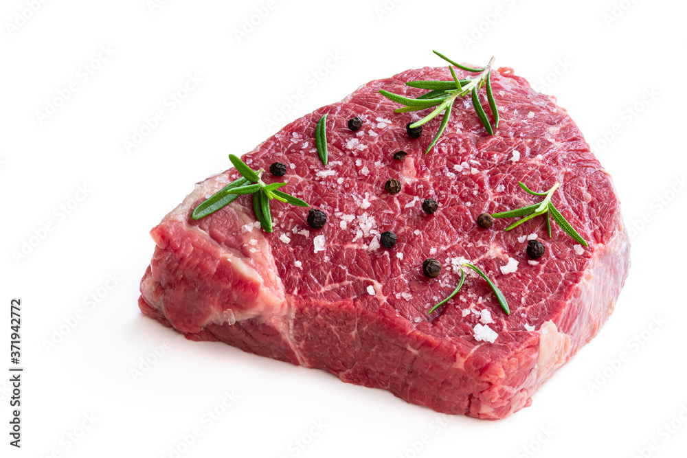Raw beef steak with herbs and spices isolated on white Raw beef steak with herbs and spices isolated on white