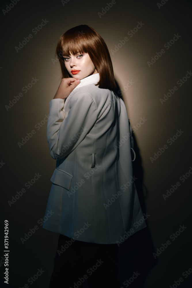  woman in fashion clothes gesticulate with hands beige background