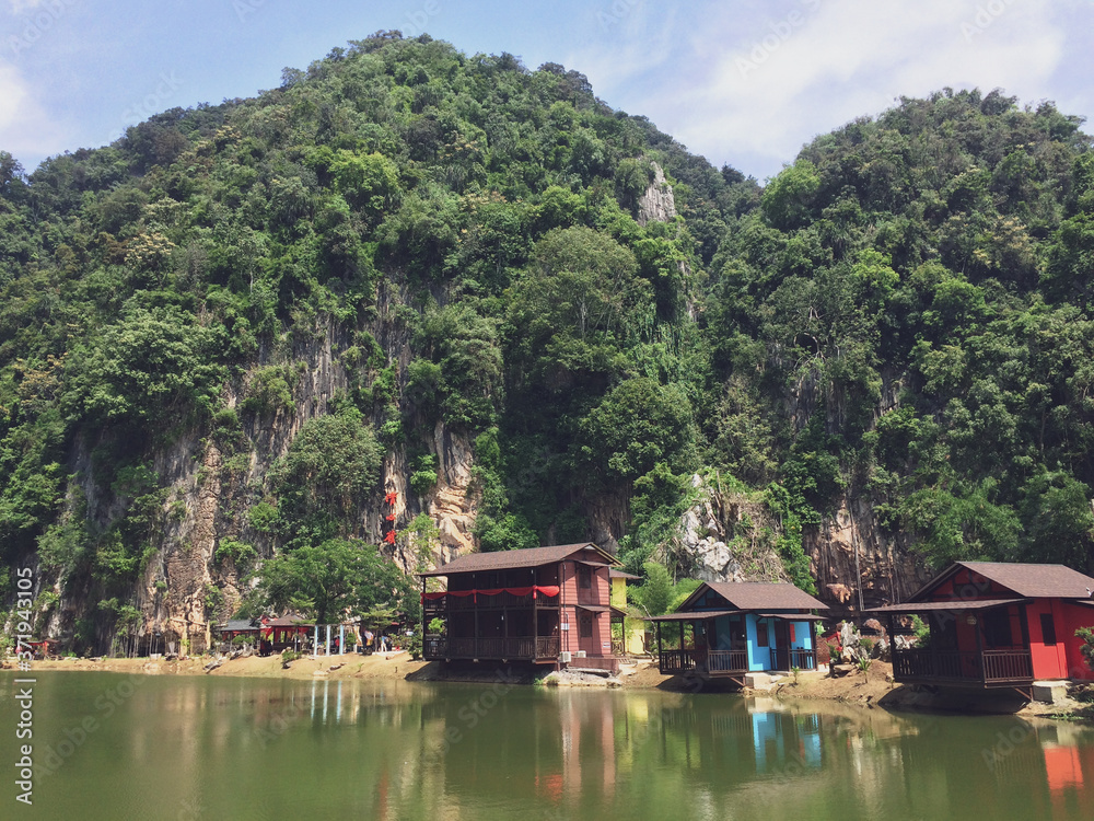 Beautiful landmark that surrounded by mountains and green facing clearly reflective lake in Ipoh, Malaysia.