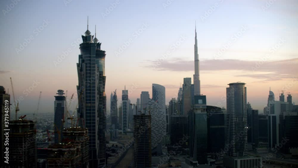 Panning through skyscrapers of Downtown Dubai while looking at the Burj Khalifa coming from behind JW Marriott Marquis Hotel, 6-axis stabilized gimbal, Shotover F1, 8K, parallax. Panning through skyscrapers of Downtown Dubai while looking at the Burj Khalifa coming from behind JW Marriott Marquis Hotel, 6-axis stabilized gimbal, Shotover F1, 8K, parallax.