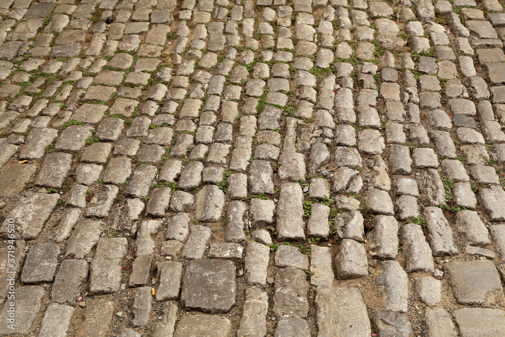 Abstract background of old cobblestone pavement close-up Abstract background of old cobblestone pavement close-up