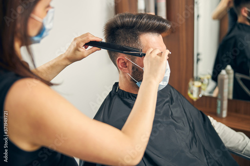 Professional stylist using sterile instruments during work