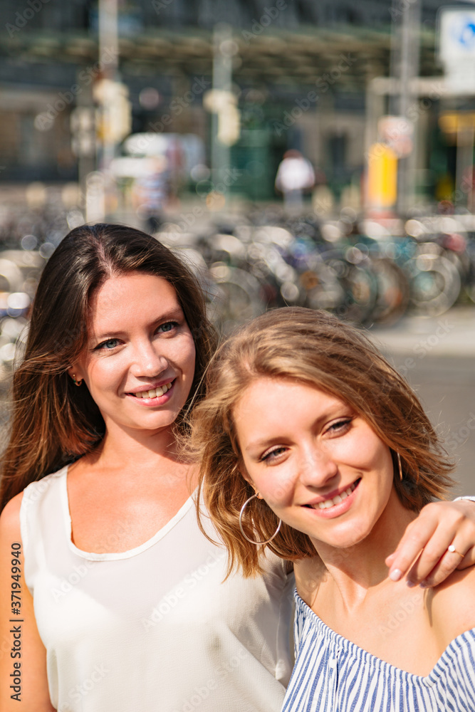 Two young girlfriends outside near each other Two young girlfriends outside near each other
