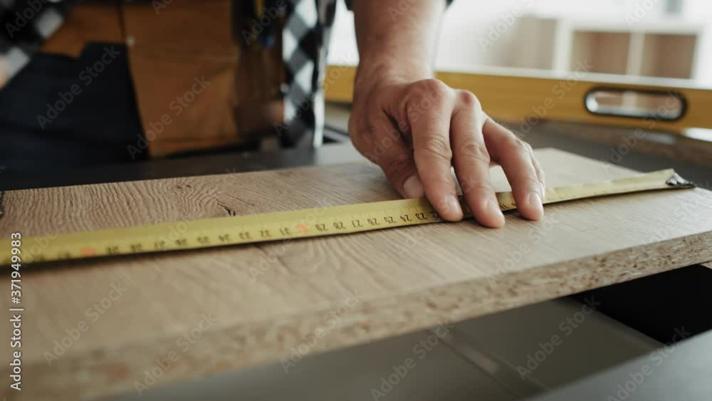 Video of carpenter designing cut lines for boards. Shot with RED helium camera in 8K Video of carpenter designing cut lines for boards. Shot with RED helium camera in 8K