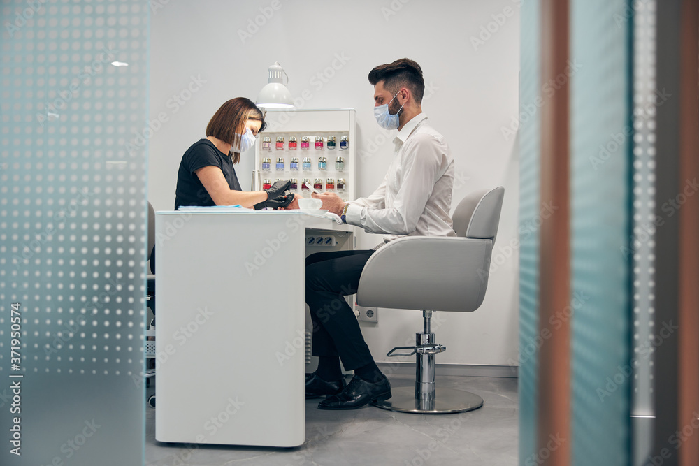 Professional master doing cleaning of nails with instrument Professional master doing cleaning of nails with instrument