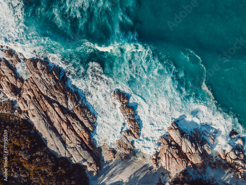 Wild ocean waves against the rocks along the beach