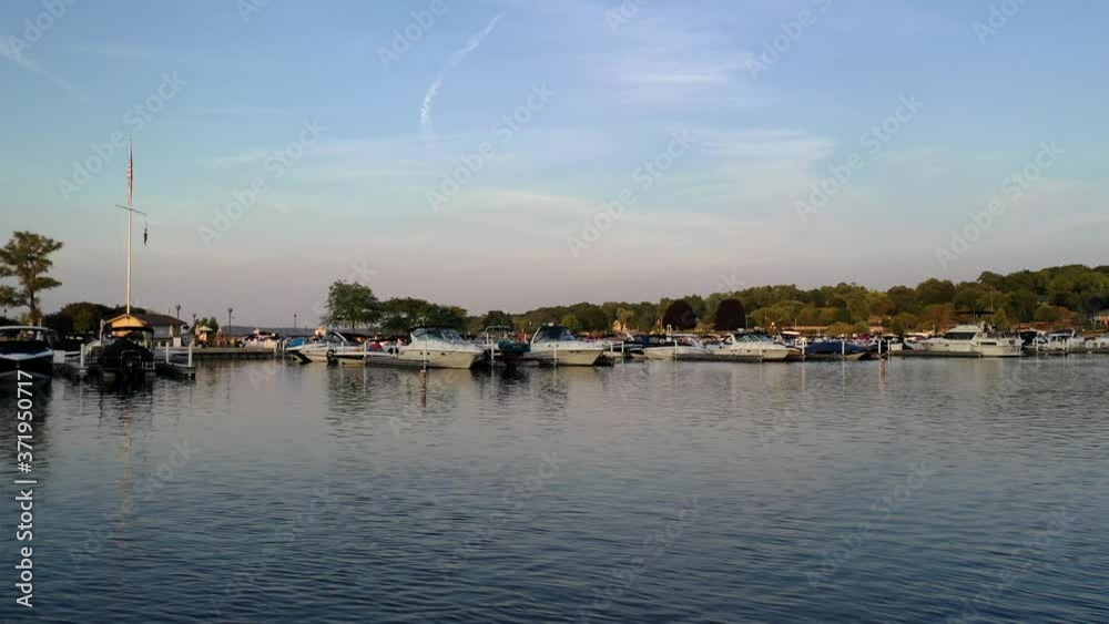 Flying Over Boat Marina with Many Moored Small Boats in Suburb Flying Over Boat Marina with Many Moored Small Boats in Suburb