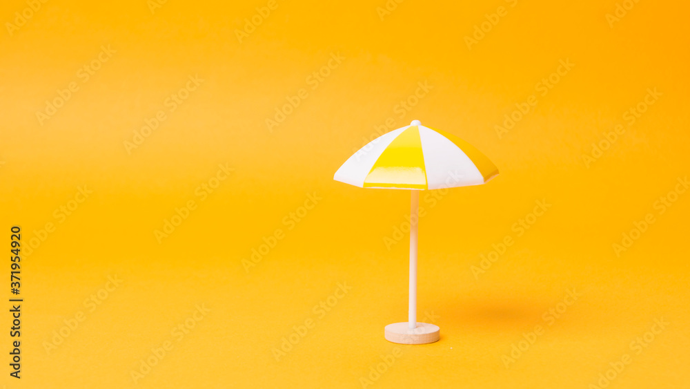 multicolored beach umbrella yellow background multicolored beach umbrella yellow background