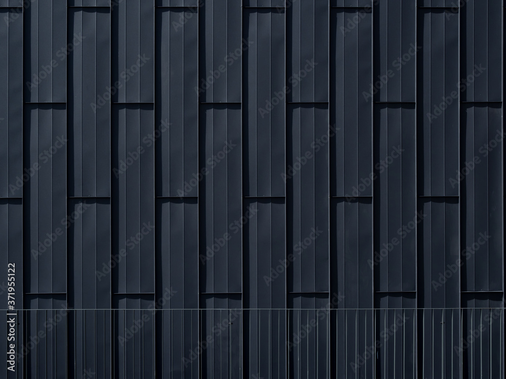 Facade decoration with black metal facade tiles.