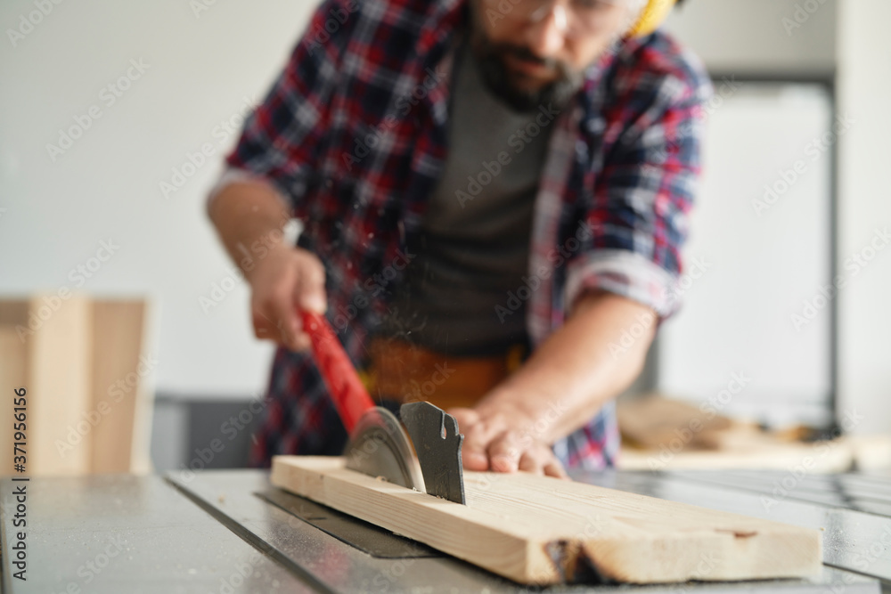 Close up carpenter using a circular saw Close up carpenter using a circular saw