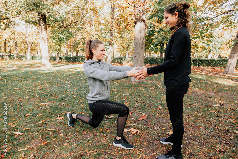 A couple of women training outdoors in the park A couple of women training outdoors in the park