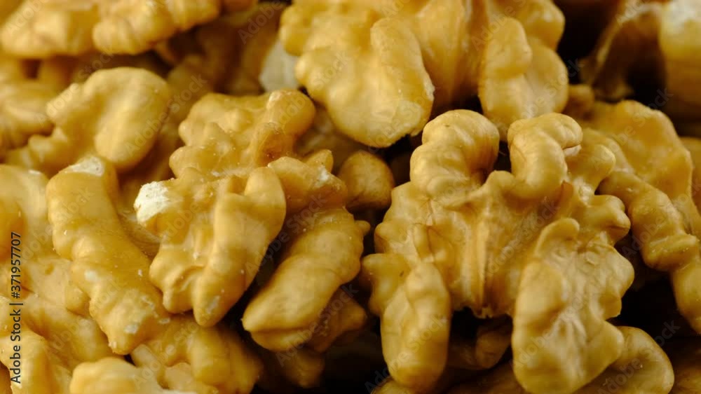 Walnuts macro background texture. Fresh raw organic walnuts closeup rotating. Walnuts macro background texture. Fresh raw organic walnuts closeup rotating.